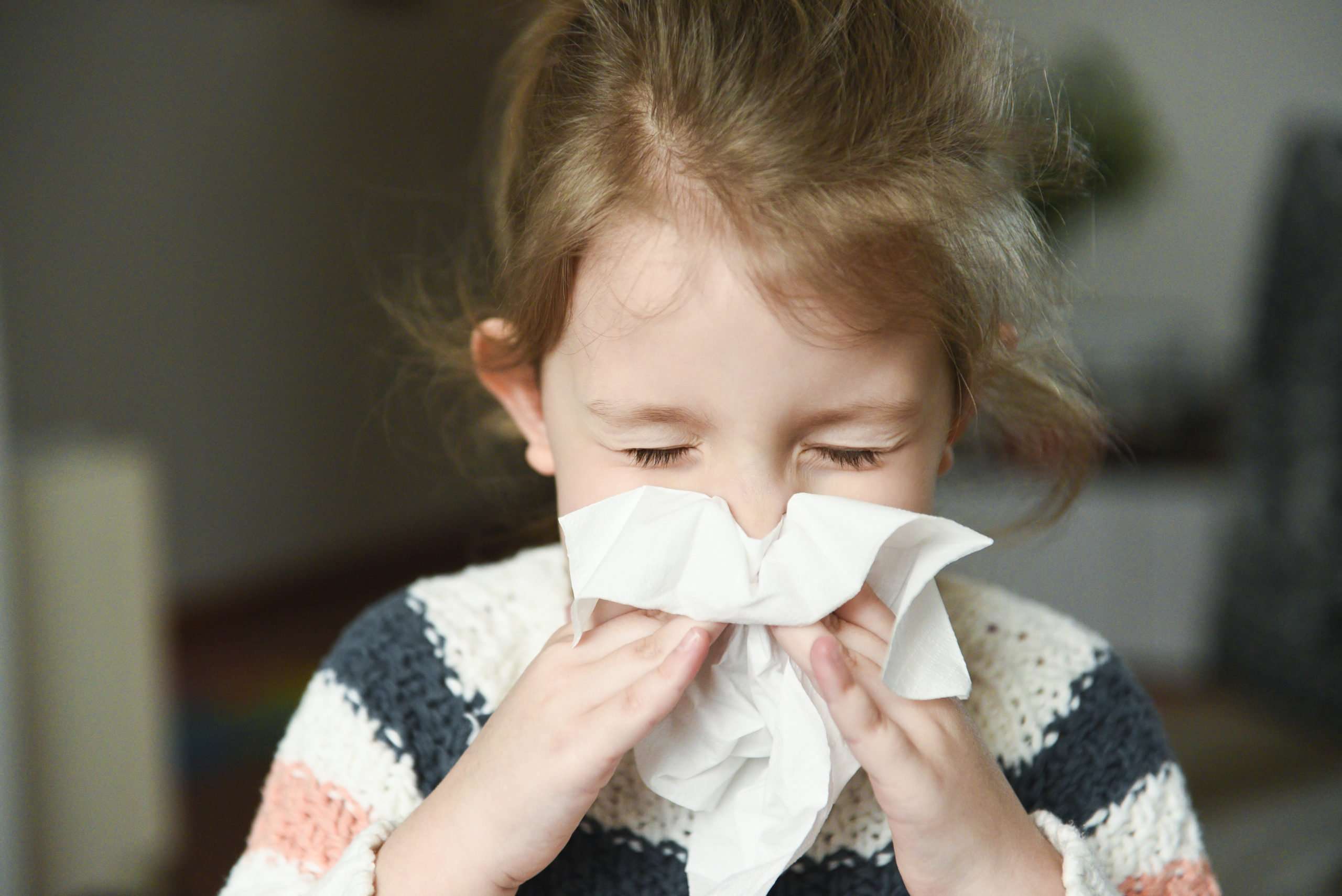 Little Girl with Allergies Blowing Nose with Tissue